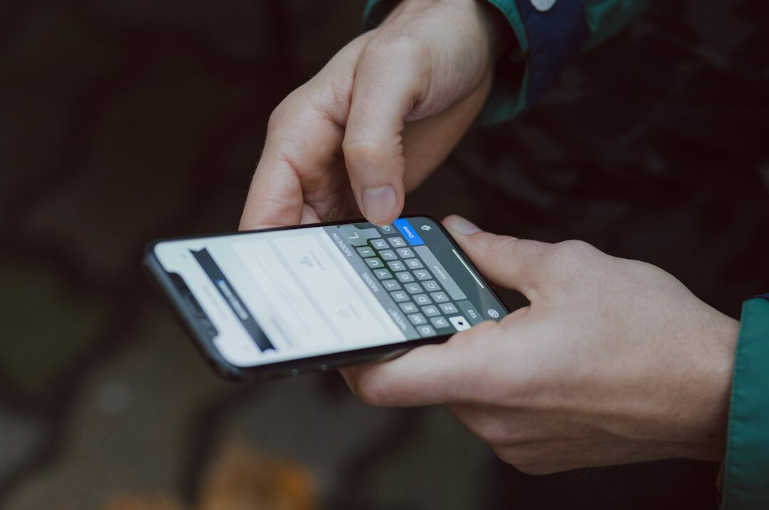 person tracking expenses on phone